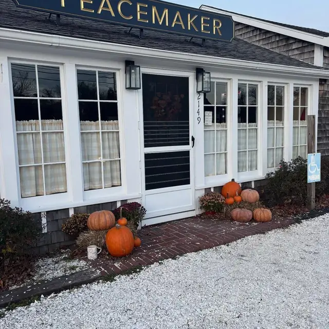 The shop doorway in autumn, pumpkins along the brick path